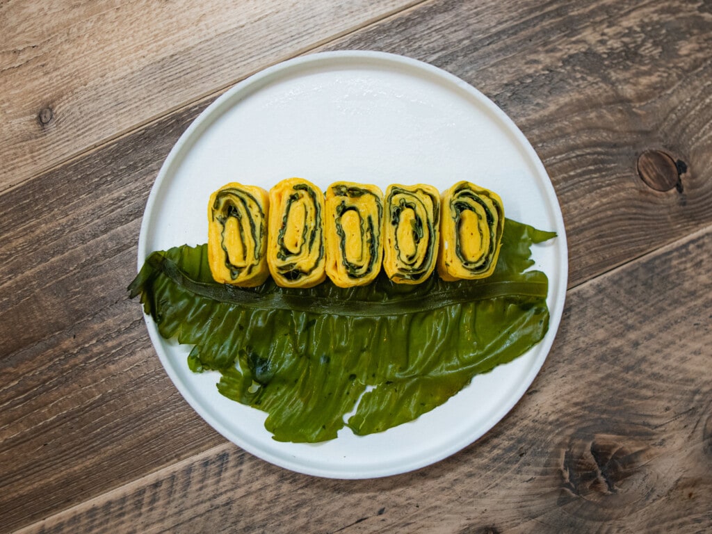 omelet rolls with winged kelp on a plate