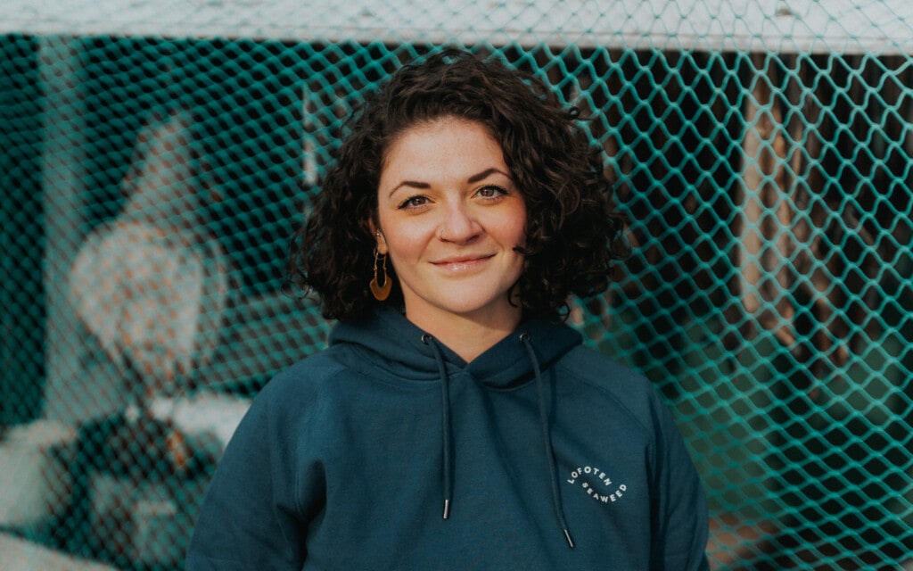 woman smiling in front of fishing net