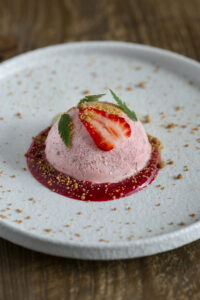 strawberry ice cream on a plate with seaweed