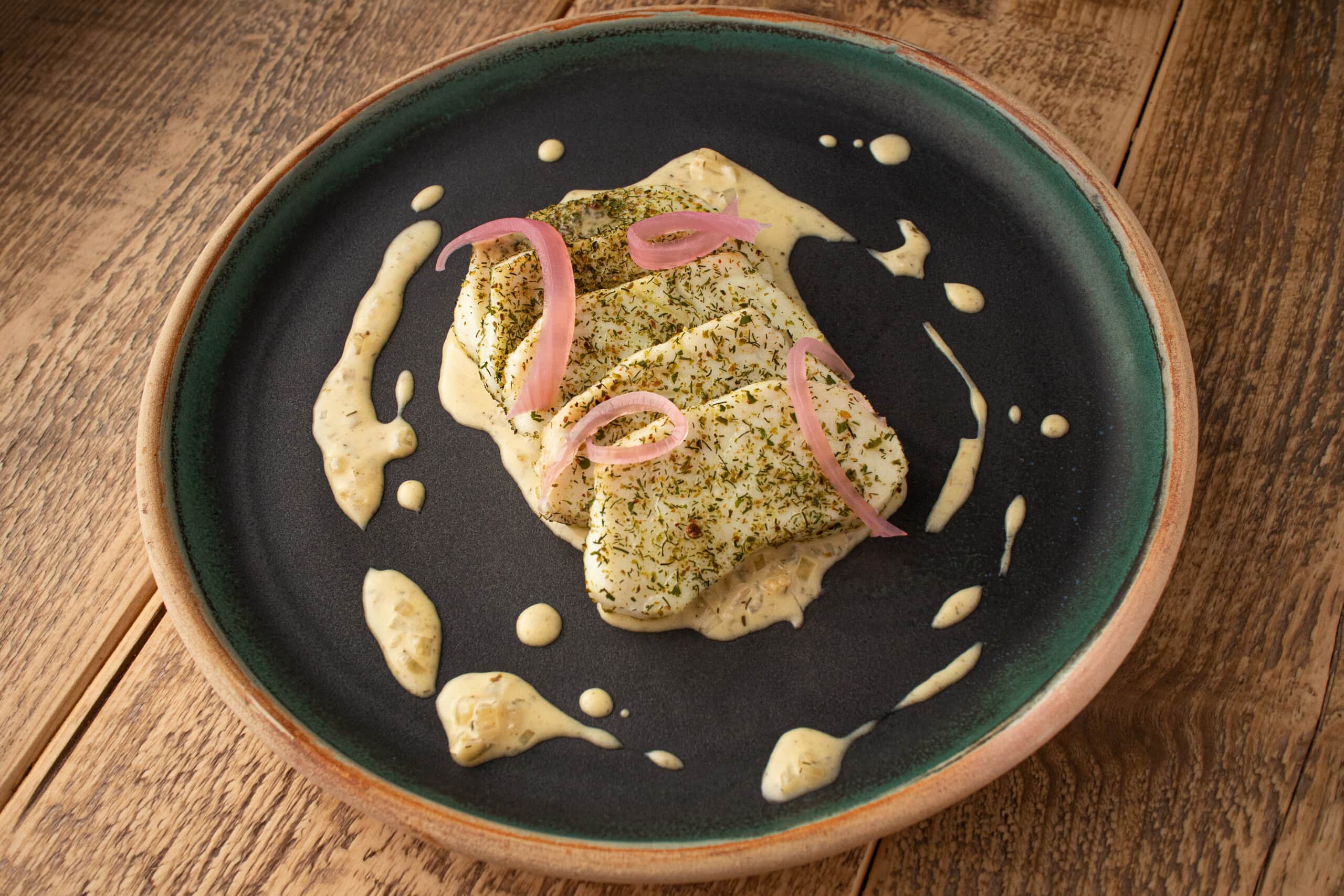 fish with pink pickled onions and seaweed