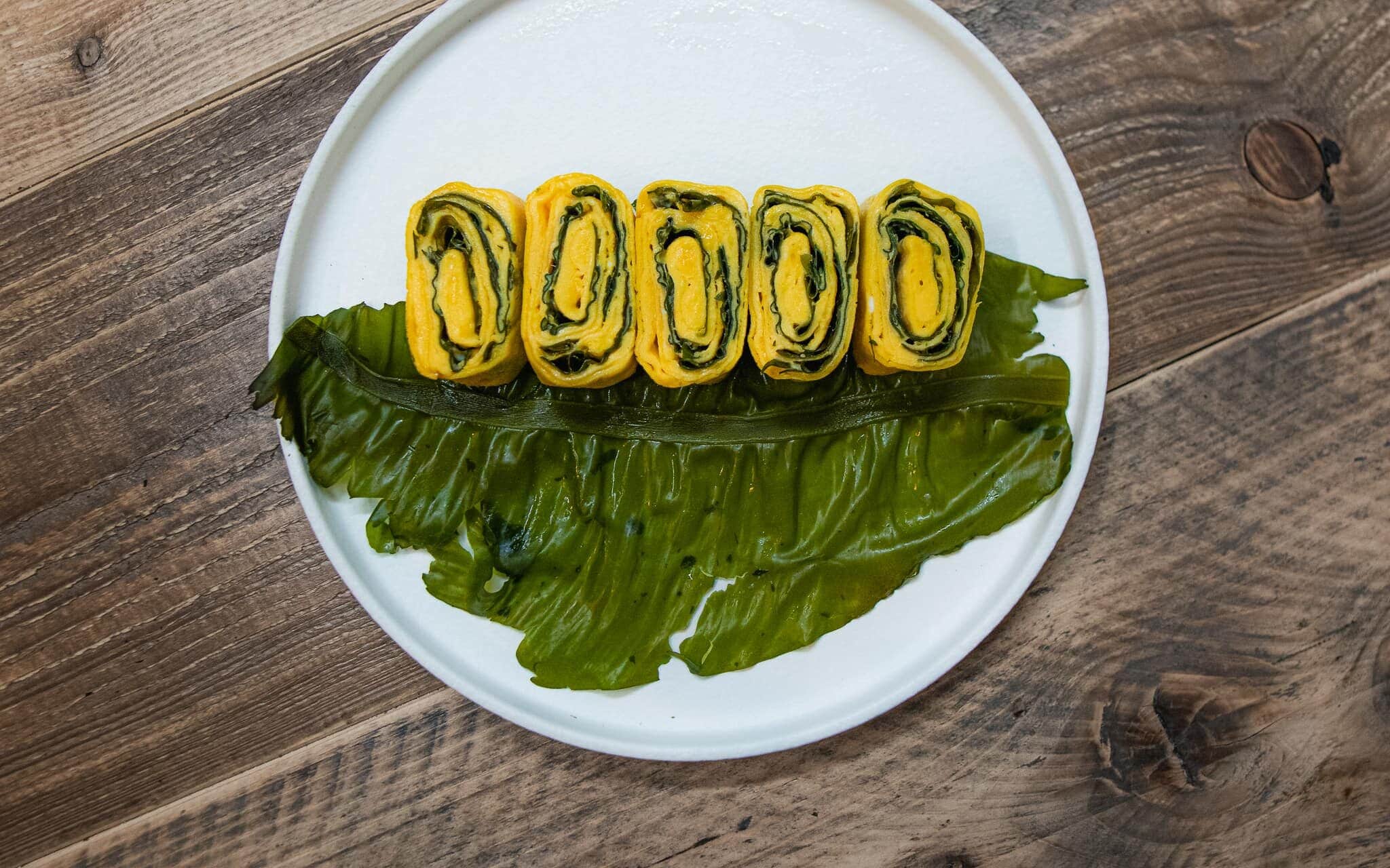 omelet rolls with winged kelp on a plate