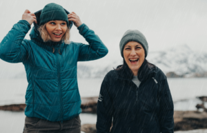 Two women laughing in the rain Rainy Day activities in Lofoten